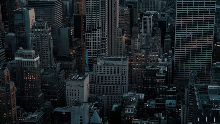 Dense cityscape with tall buildings at dusk.